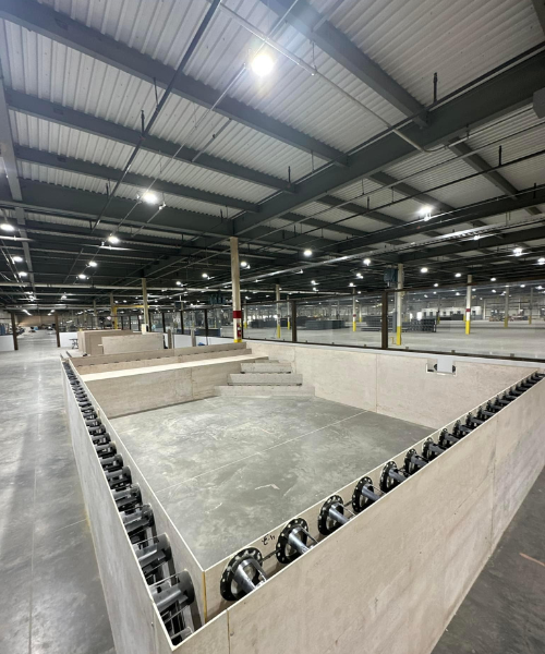 A skateboard park in a large building with lots of lights