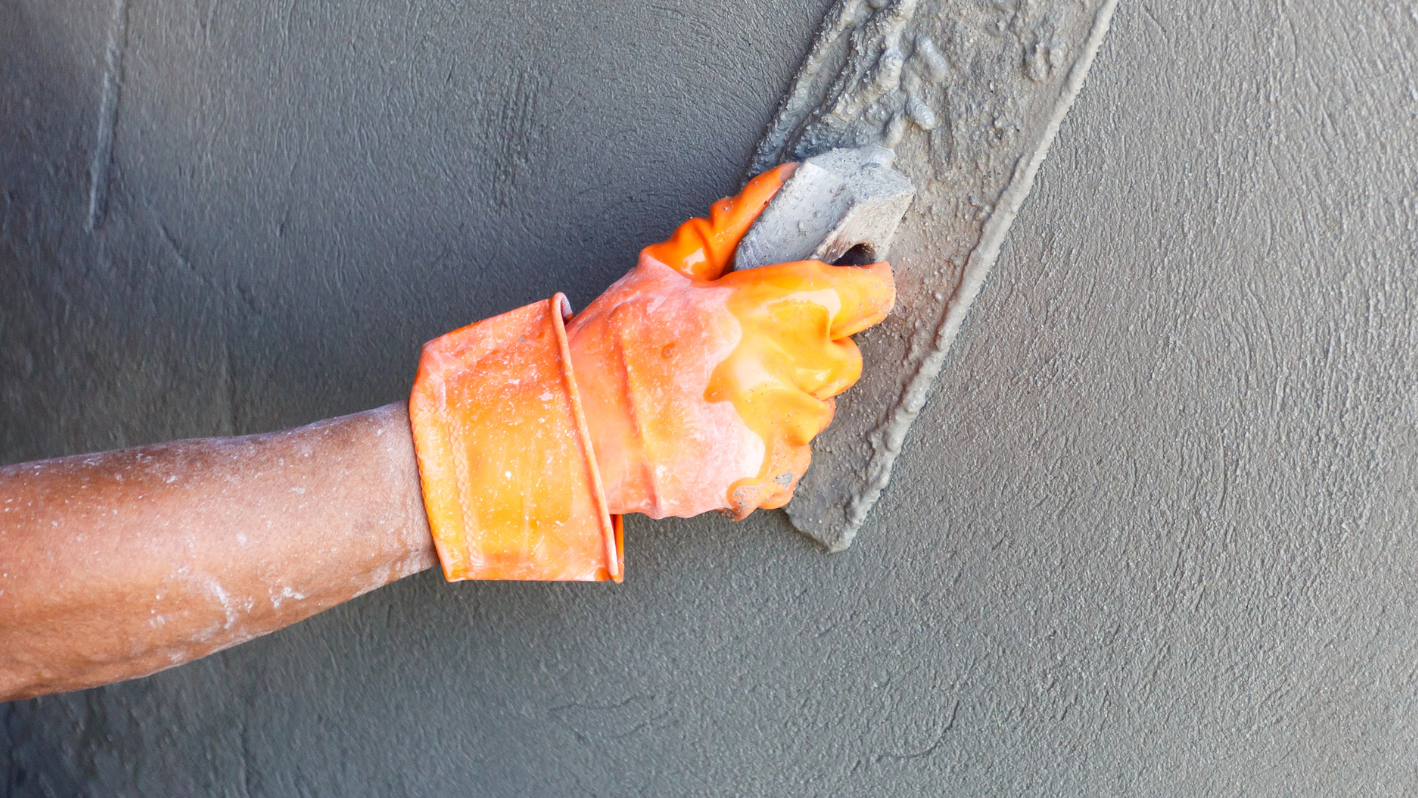 A person is holding a piece of orange material